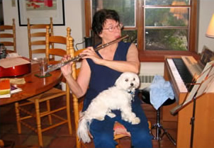 AC practicing the flute with captive canine audience